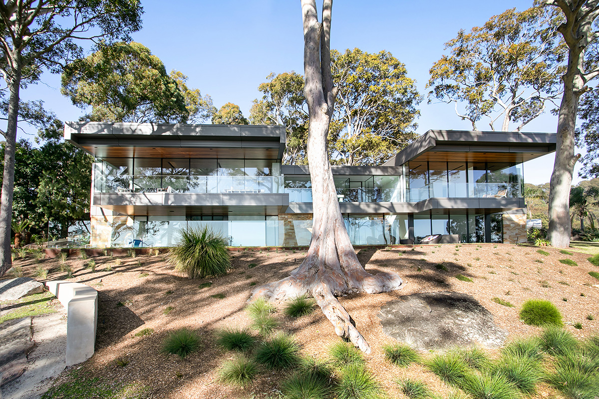 Sydney sandstone and white corona cladding with cantilevered balconies and roof forms